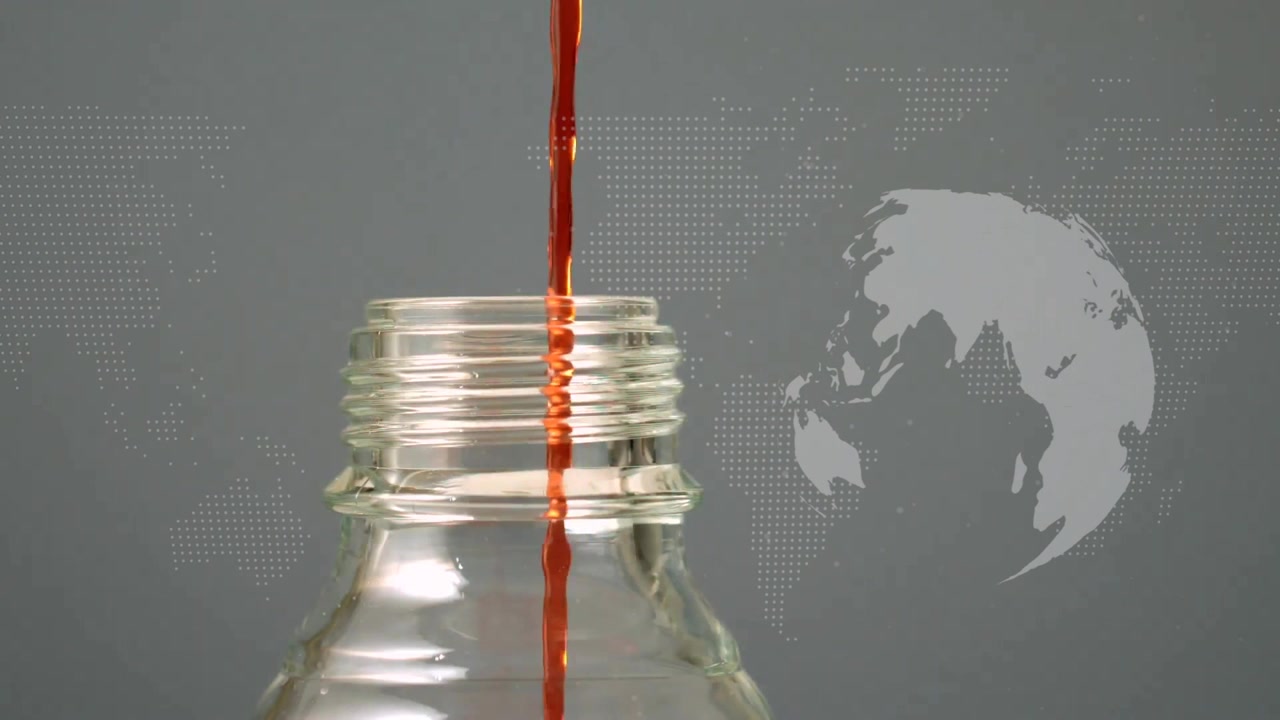 Single red droplet appearing above glass bottle neck, merging into stream filling bottle