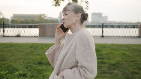 senior woman talking on phone in park