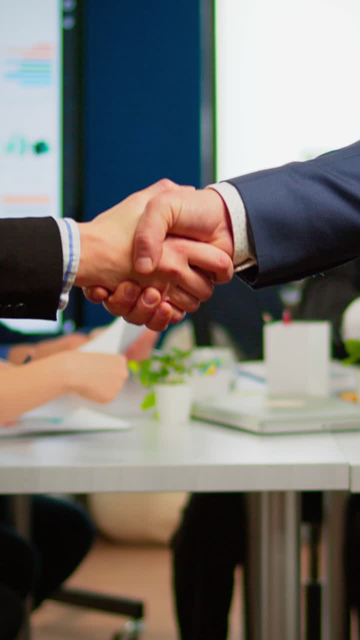 Vertical video Satisfied businessman company employer wearing suit handshake new employee