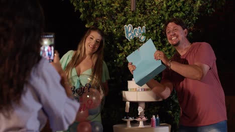 joyful gender reveal party unveils baby's gender with balloons and cake
