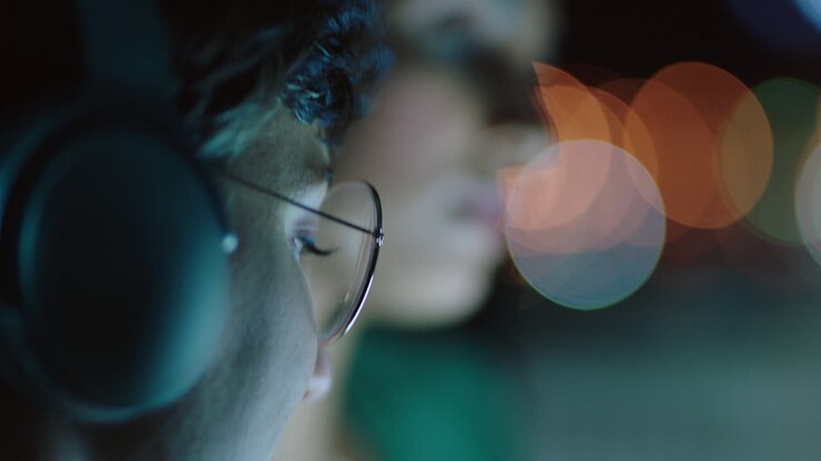 business team working late colleagues using tablet computer brainstorming ideas for project deadline manager woman sharing strategy meeting in office at night wearing headphones close up