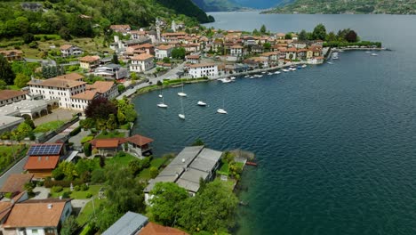 aerial flyover of picturesque italian village on shore of lake orta, italy