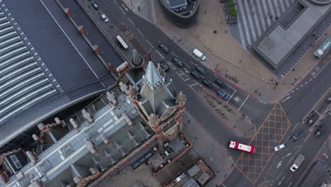 High-angle-rotating-footage-of-historic-clock-tower-above-road-intersection.-St-Pancras-train-station-and-surrounding-streets.-London,-UK