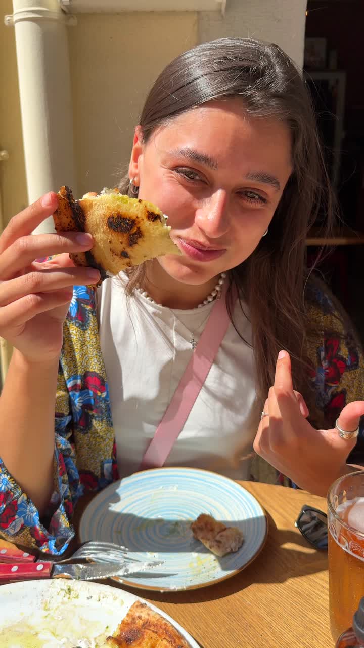 Woman enjoying a slice of pizza