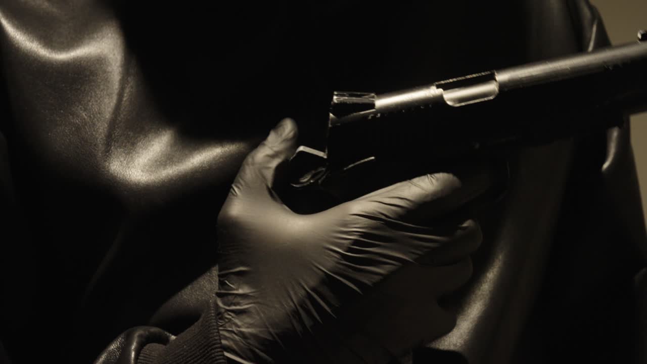 a gun is loaded close up, the tap is pressed down with the thumb