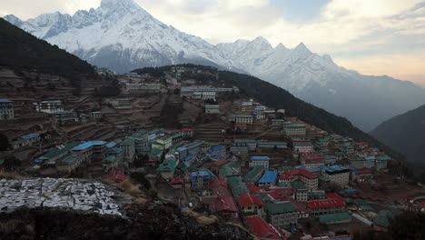 views over namche bazaar at sunset with views of snow capped mountains, nepal.