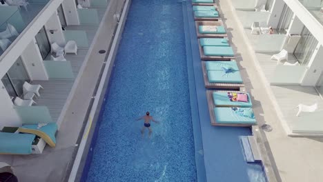aerial view of a man swimming in the pool, top view