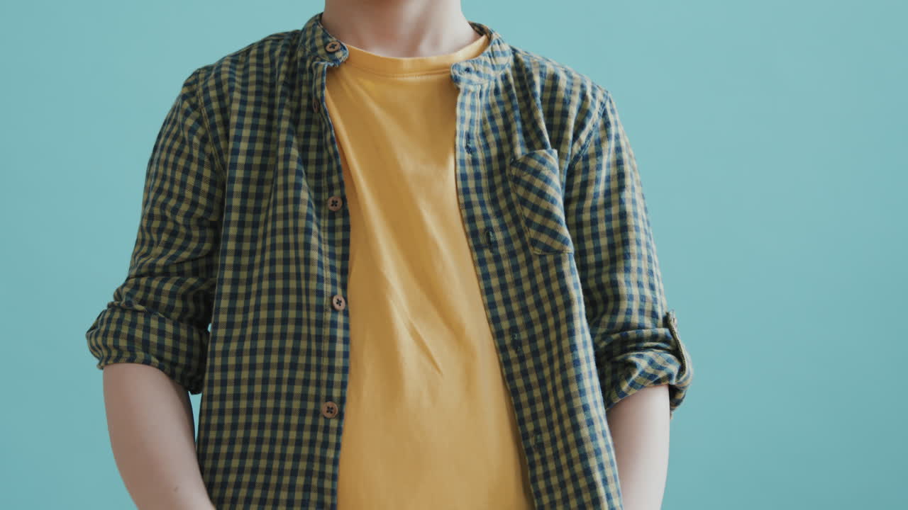 Boy Posing Against Blue Background