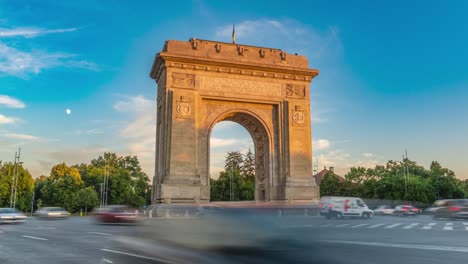 sunset over the arch of triumph in bucharest, romania