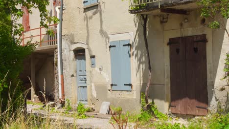 old stone facade with blue shutters in quaint glandage village, rhone alpes, france