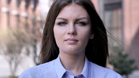 portrait of serious young woman looking at camera