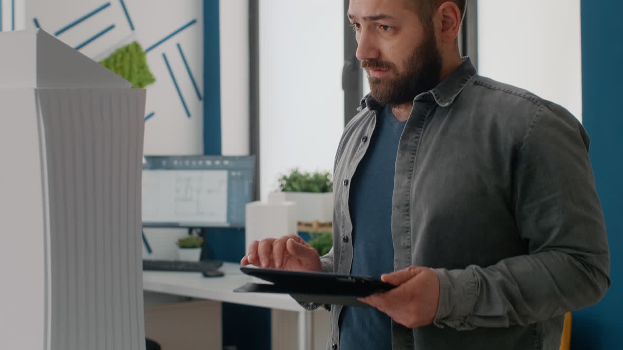 Architect working on building design using tablet in office