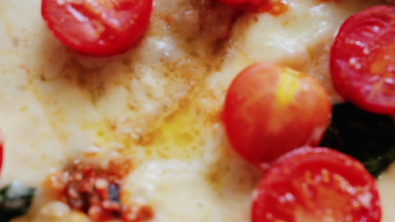 Close up of a classic margherita pizza with cherry tomatoes and basil