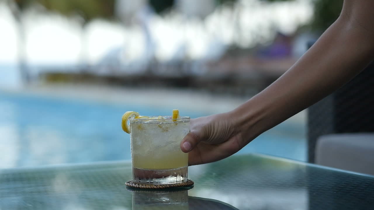 Cool fresh class of lemonade by the hotel pool with ice