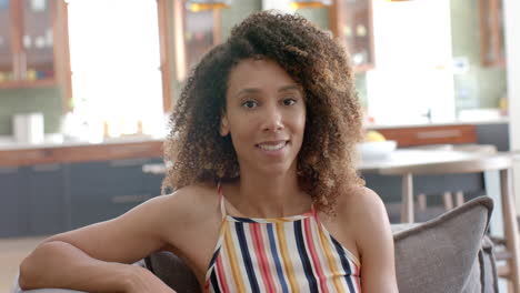 Biracial-woman-smiles-in-a-casual-indoor-setting