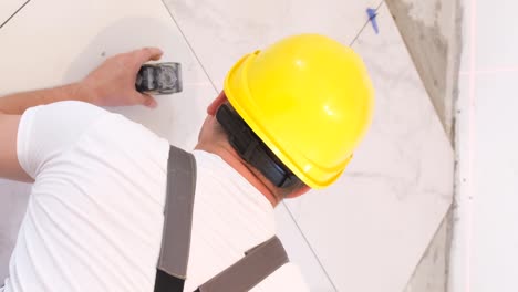 a worker laying large wideformat floor tiles