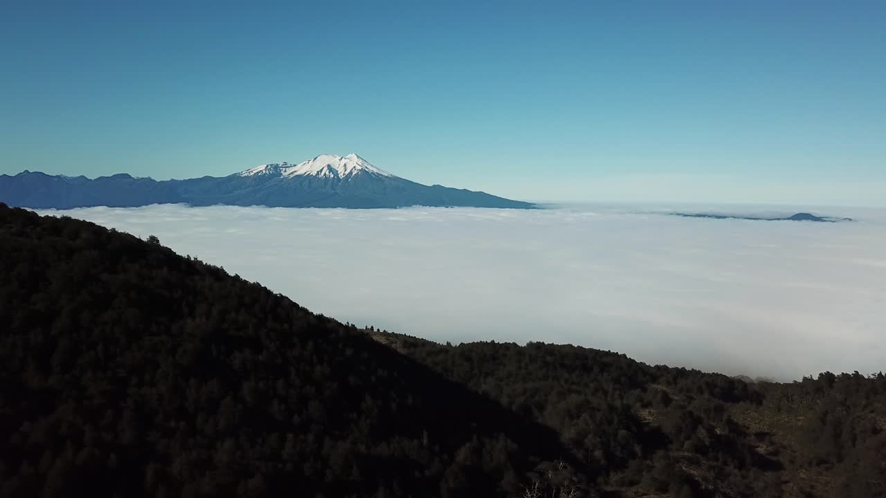 Breathtaking Landscape Aerial View of Highlands of Chile. Dense Clouds in Valley Under Snow Capped Volcanic HIlls