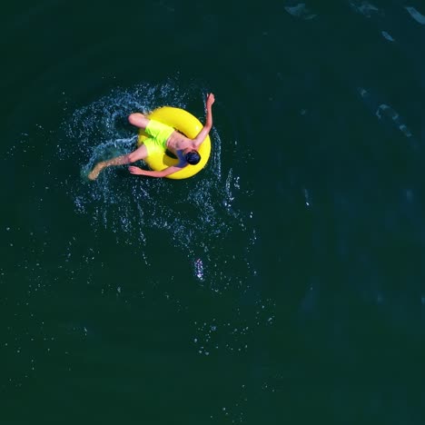 boy swimming with swim ring