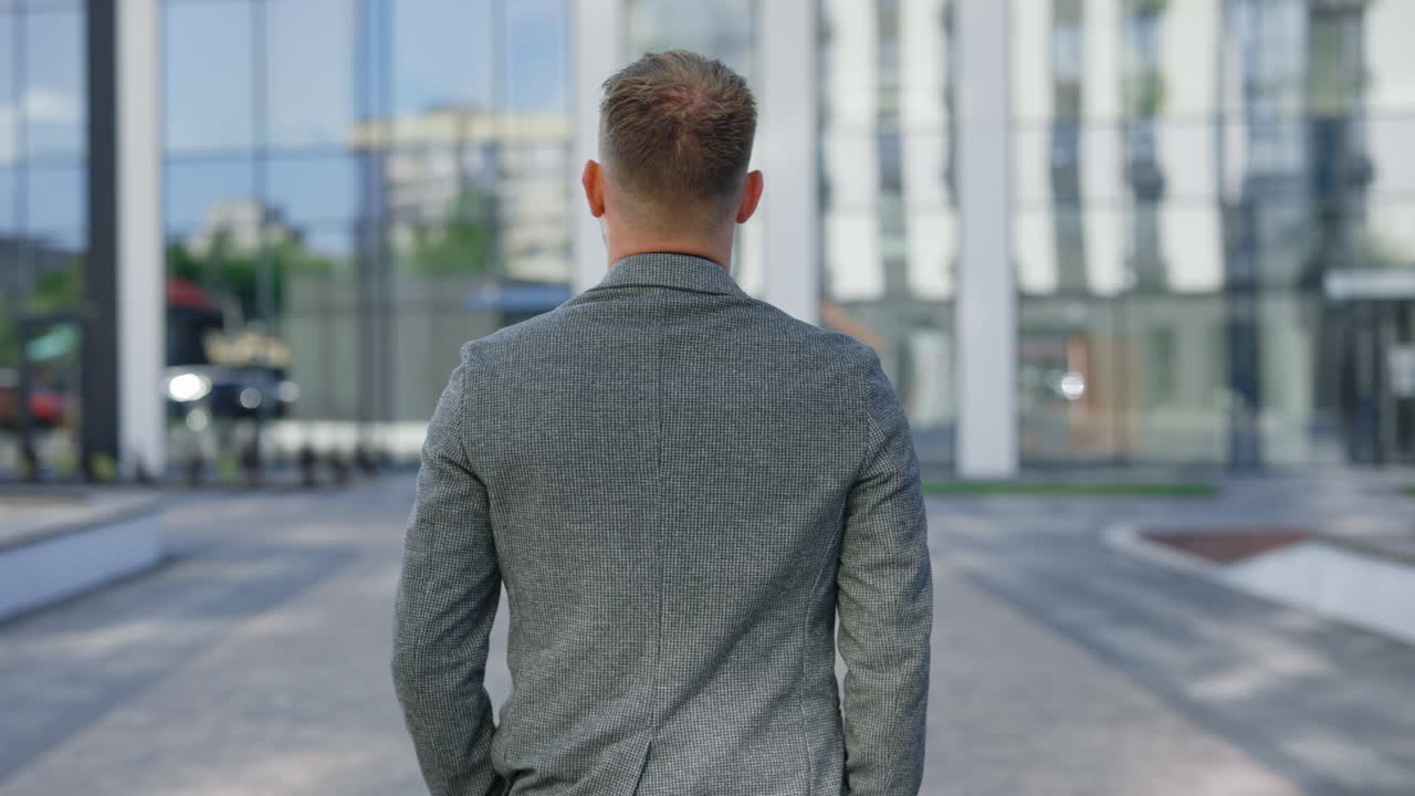 Businessman walking outside a modern building