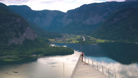 cinematic tracking shot of a girl and a dog on hallstatt skywalk