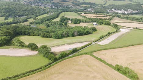 Aerial-view-of-new-infrastructure-being-laid-through-the-UK-countryside,-showcasing-development-and-surrounding-fields