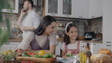 mother and daughter cooking together in kitchen