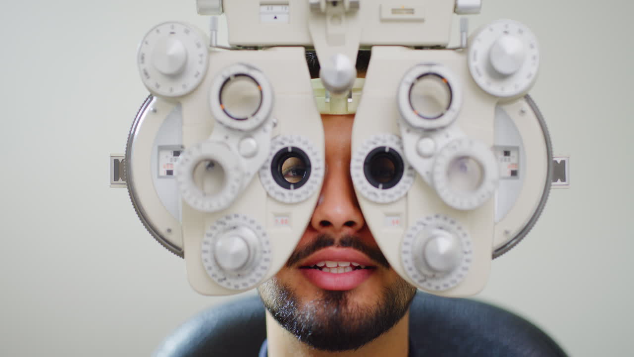 Male patient doing eye test with optometry