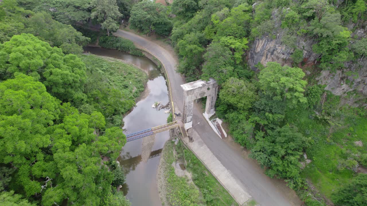 Majestic view of birds over lush green hills and La Puerta del Llano Monument