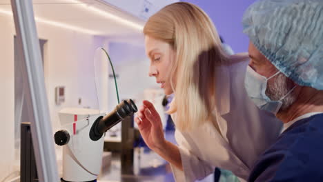 scientists working with microscopes in a laboratory setting