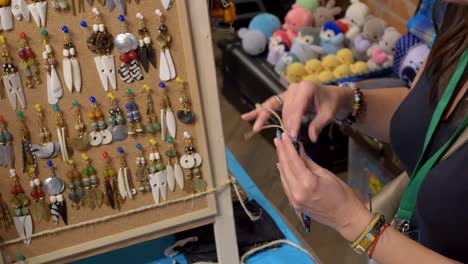 a salesperson is packaging a customer's colorful bracelet