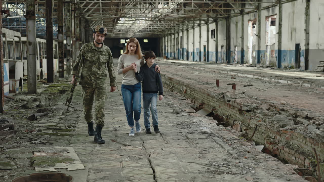 Un soldato protegge una famiglia durante una guerra