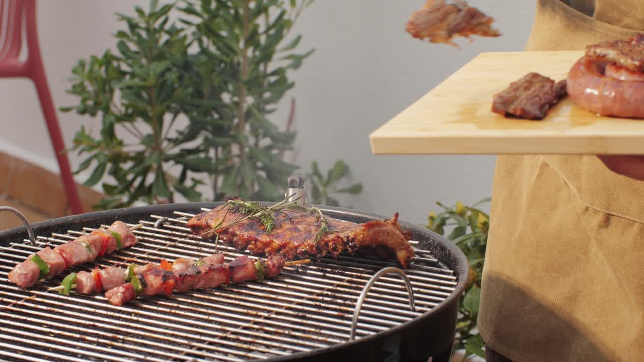 Traditional spanish barbeque, big sausage chorizo botifarra, pork and beef ribs on grill with fire, american style cooking, chef grilling meat fat food, steaks and sausages on bbq. High quality 4k footage