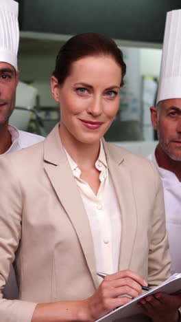 serious restaurant staff with manager looking at camera