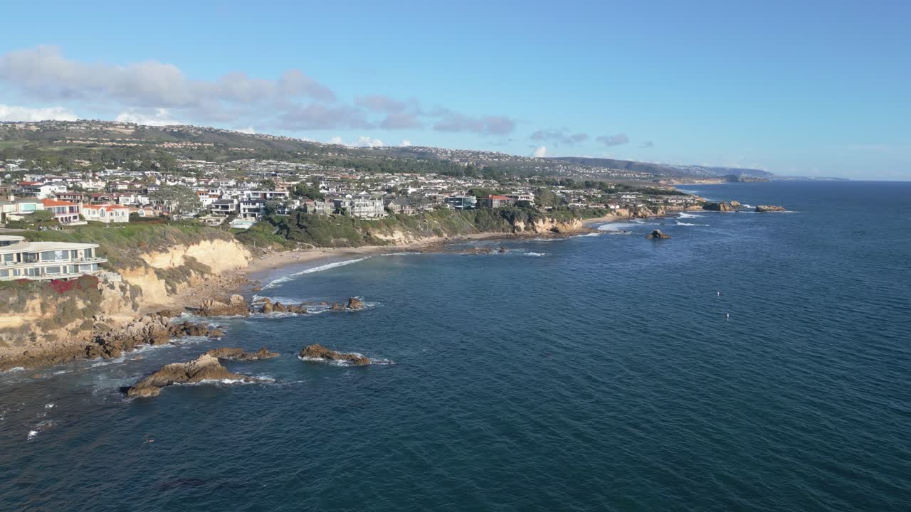 4K drone shot flying over ocean and shore at Laguna Beach during golden hour. Slow motion capable, ideal for travel, coastal, cinematic, or nature projects