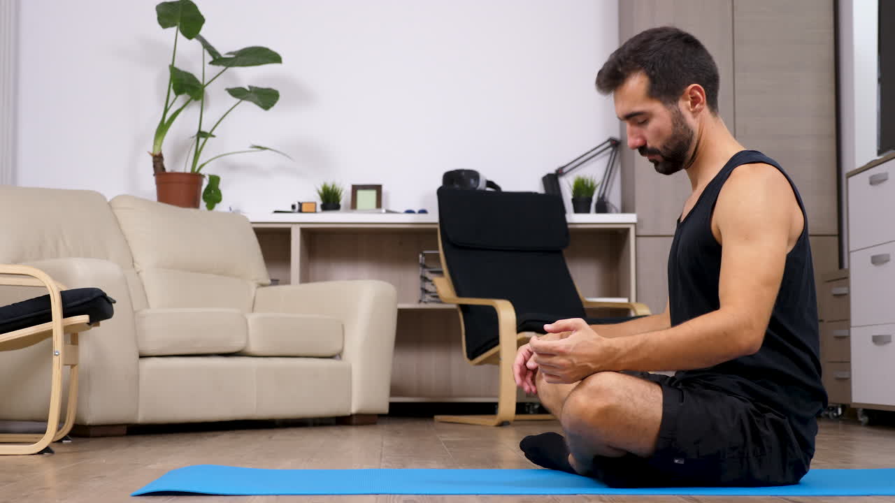 Man doing yoga and stretching exercises at home
