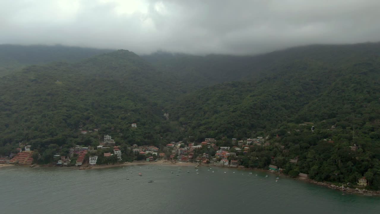 Idyllic Town Of Yelapa At The Foothills Of Forest Mountains Under Gloomy Sky In Jalisco, Mexico. Aerial Wide Shot