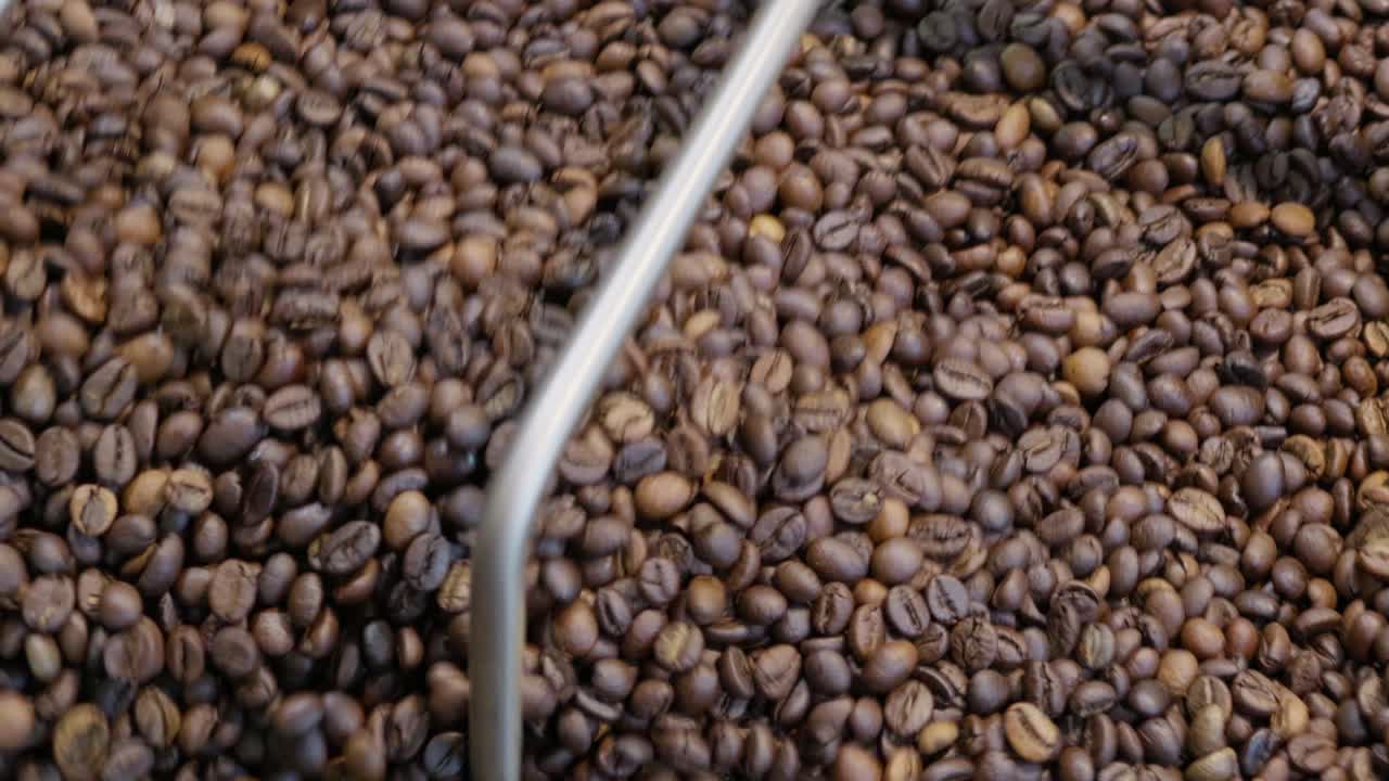 Discover the art of roasting coffee beans enhancing flavors in a cozy artisan workshop.