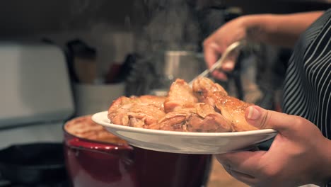 taking the steaming hot chicken thighs out of the dutch oven to serve - pot roasted chicken series