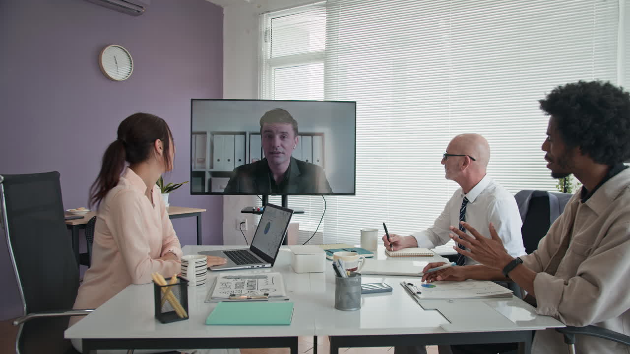 Team of Colleagues Having Online Meeting with Employee at Office