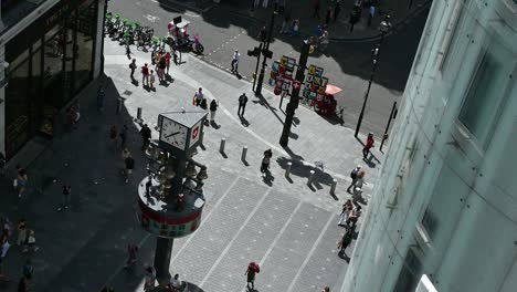 aerial view of a busy city street with a clock tower and pedestrians