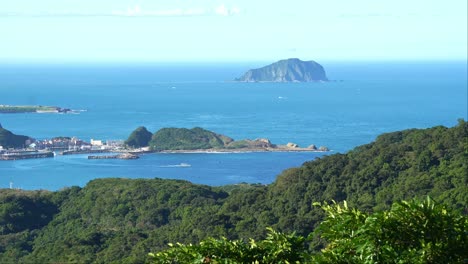 serene landscape views from jiufen mountain town of shen'ao fishing harbor and keelung islet at daytime, ruifang district, new taipei city, taiwan, foliages swaying gently in the breeze