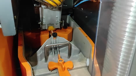 Automatic Orange Juice maker machine, working on squeeze out oranges for juice