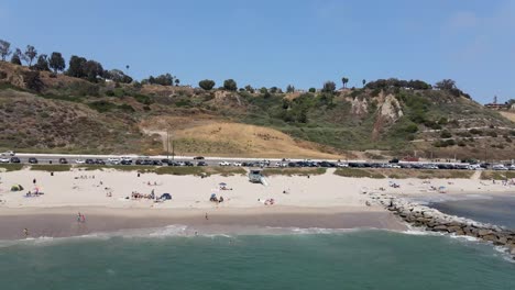 Flying-over-busy-beach-in-Malibu-California