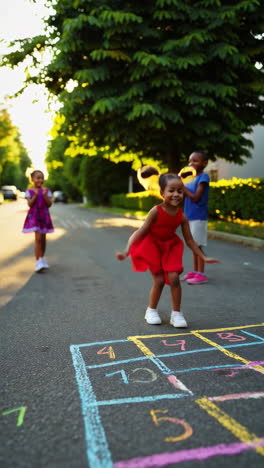 children playing hopscotch outdoors