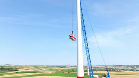 Wind-Turbine-Head-Construction-In-Agricultural-Fields---aerial-shot