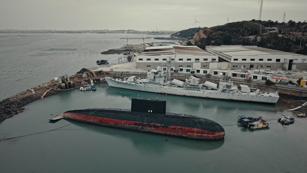 Aerial View of Submarine and Warship Docked in a Coastal Harbor