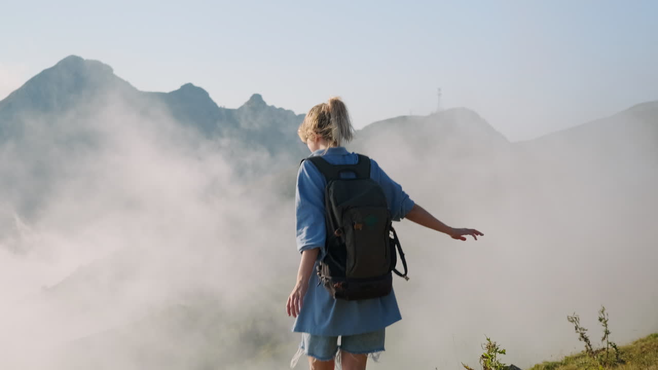 Woman Hiking Through Misty Mountains