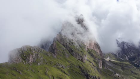 iconic monte seceda with jagged towers in clouds, puez odle nature park