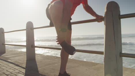 Senior-man-in-pain-holding-his-leg-on-the-promenade