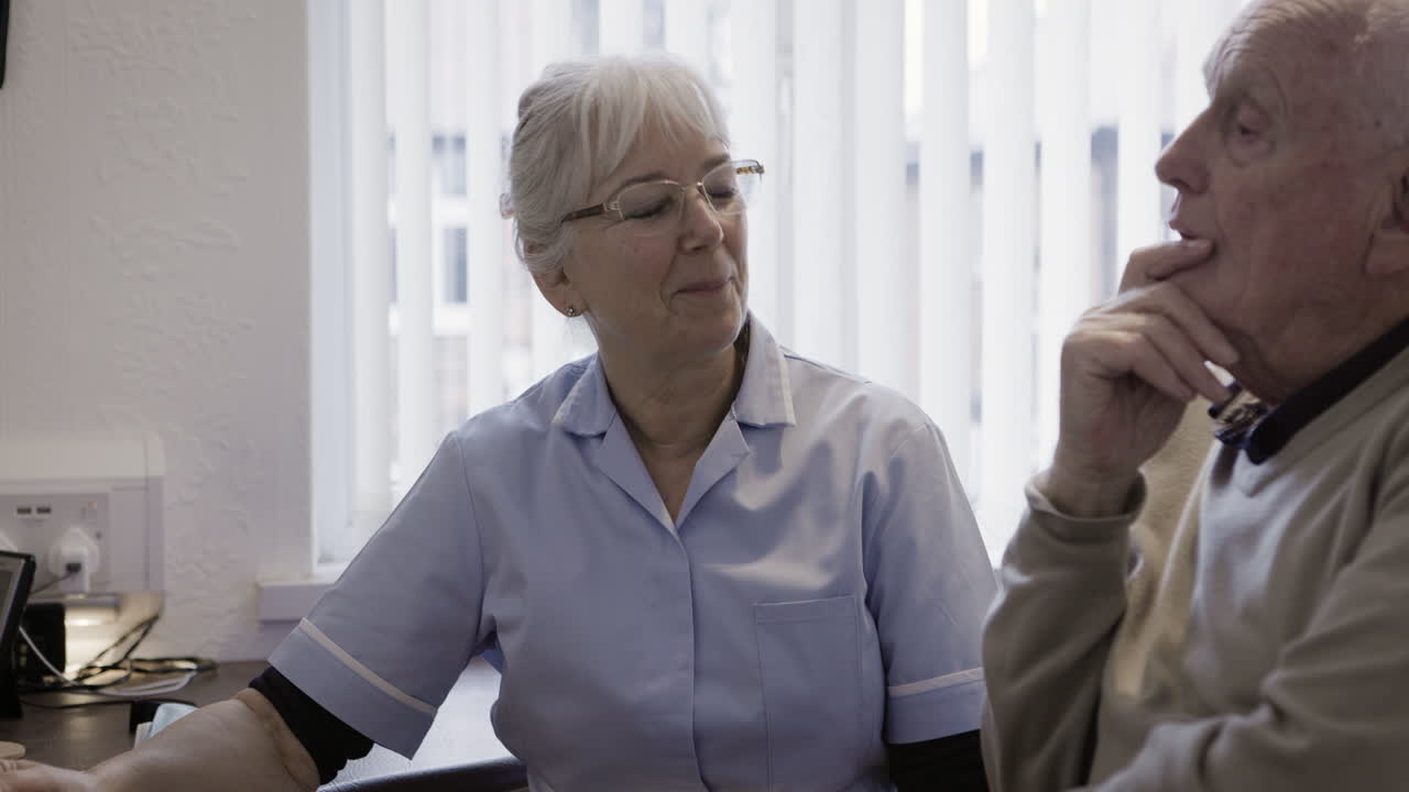 Nurse caring for elderly man